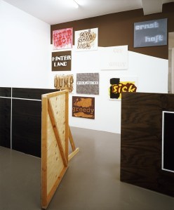 Daniela Brahm Hinterland, 2002 Mirko Mayer Gallery, Cologne “Hiding”, wooden fence, 120 x 750 cm paintings from the series “difficult characters”, oil on canvas, 60 x 70 cm each, emulsion on wall